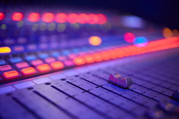 View of music mixer in concert, filled with lights.