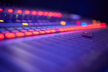 View of music mixer in concert, filled with lights.
