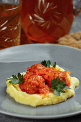 Meatballs in tomato sauce with mashed potato on the white plate, top view, view from above