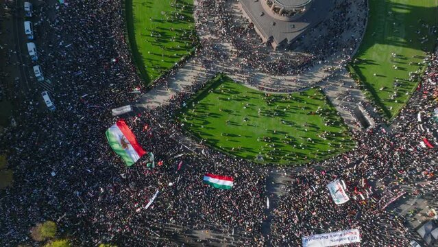 Top down panning footage of huge amount of protesting people with Iranian flags and banners on square. Berlin, Germany