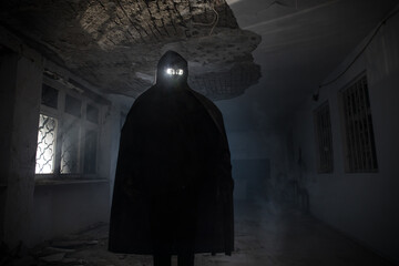 death with scythe standing in the dark hall of abandoned building.