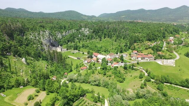 Predjama Castle - Postojna Cave Park Slovenia castle hidden in a cave rock Aerial shot drone 4k full hd landscape view europe historical 