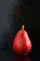 Macro Image of Wet Red Pear on Black Background