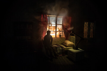 Man comfortably sleeping in his bed at night. A realistic dollhouse bedroom with furniture and...
