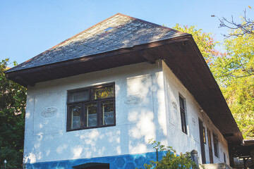Facade of old peasant house in autumn season.
