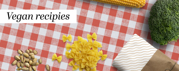 Fototapeta premium variety of cooking ingredients and message VEGAN RECIPIES on kitchen table background