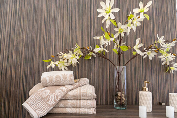 New clean towels are neatly stacked on the shelves in the store. The interior of a modern bathroom in a hotel. Shelves with bath accessories in the new relaxation room.