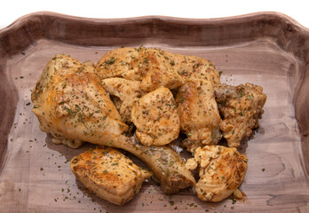 A porcelain tray with garlic chicken, on a white background. Spanish food concept.