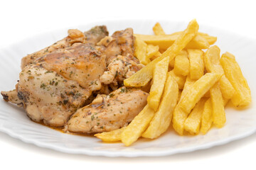 A plate of garlic chicken with pommes frites. On white background. Spanish food concept.