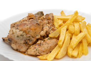 A plate of garlic chicken with pommes frites. On white background. Spanish food concept.