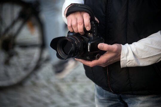 Strasbourg - France - 22 October 2022 - Closeup of canon camera in hands of photographer shooting in the street in live view