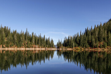 Fototapeta na wymiar alpine lake reflection with blue skies