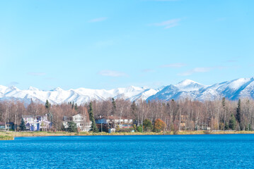 Lakeside row of duplex houses with downtown Anchorage buildings office towers in background from...