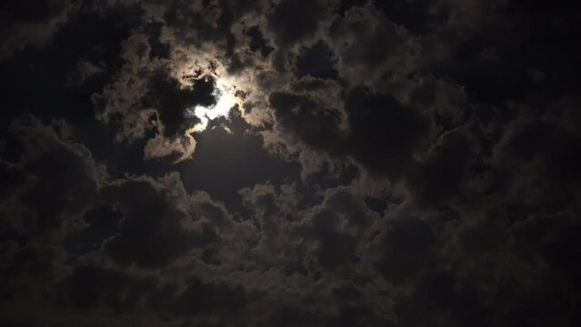 Full moon in the clouds at night.