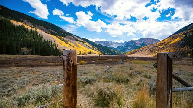 Time Lapse Shot Of Forest On Rugged Mountain Range Under Cloudy Sky - Elk Mountains, Colorado