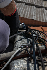 unrecognizable person installer of aerial technology cable and internet with security