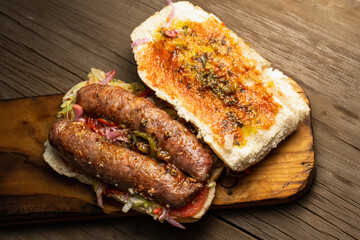 choripan chorizo sandwich on bread with vegetables and chimichurri