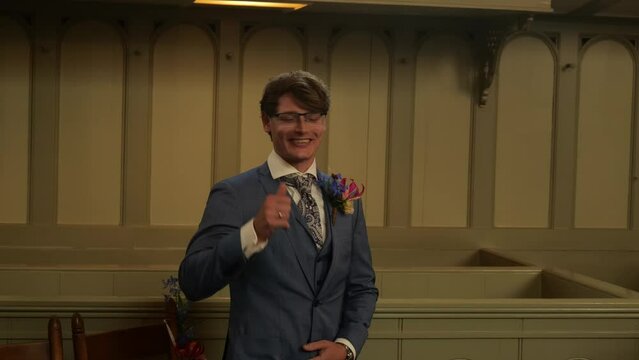 Handsome Caucasian Groom Wearing Suit Inside The Chruch Hall At Wedding Ceremony. Medium Shot