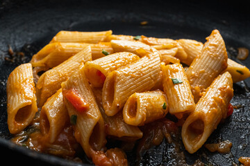 penne noodles with red tomato sauce and vegetables