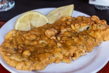 escalope of fried fish with lemon
