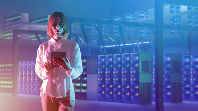 Data center manager. Woman data center specialist. Girl with tablet in server room. Woman monitors health of servers. Data center manager is standing indoors. Banner for hosting provider. Art focus - Powered by Adobe