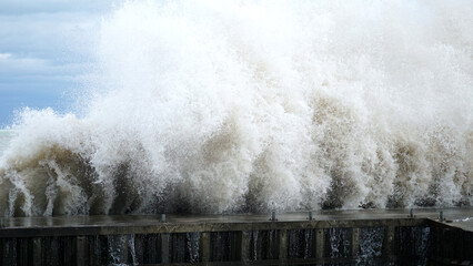 A wave crashes into a break wall along Lake Michigan’s shoreline at Tower Beach in Winnetka, Illinois, on a very windy day.