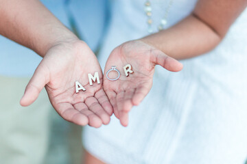 couple holding amor sign