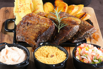 barbecue roast beef with rice, boiled cassava salad, farofa and beans, typical Brazilian cuisine