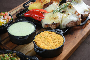 barbecue roast beef with rice, boiled cassava salad, farofa and beans, typical Brazilian cuisine