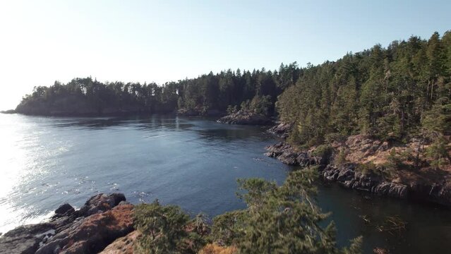 A aerial drone shot of the beautiful coastline, ocean, West Coast Canada, with turquoise water near Sooke, BC. 4K 24FPS.
