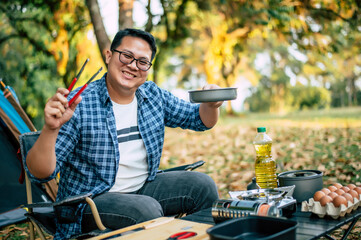 Portrait of Asian traveler man glasses frying a tasty fried egg