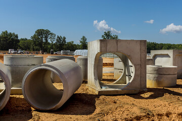 Concrete sewage pipes of large diameters on construction site to construct drainage systems for...