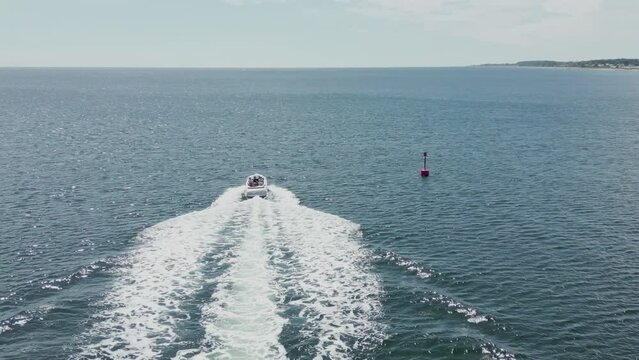 Drone view of the white boat driving in the water, Fehmarn island, Germany, aerial