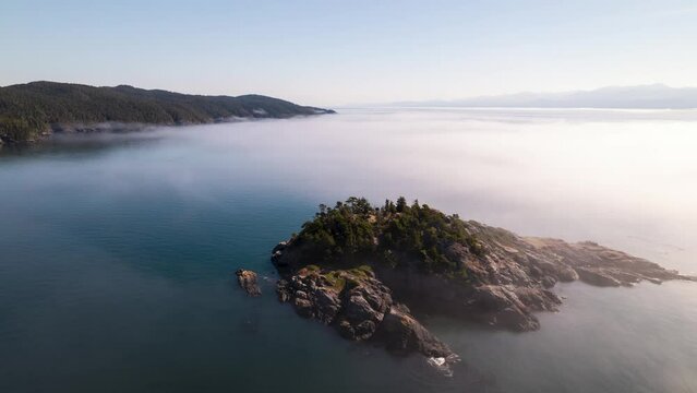 Aerial hyperlapse above clouds, fog bank, coastline of Vancouver Island, Sooke, BC. 4K 24FPS