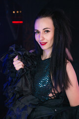 Beautiful girl dancer posing on the stage of a nightclub. Party concept