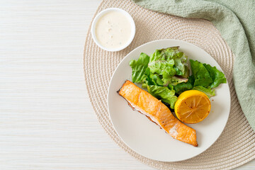 fried salmon steak with lemon and vegetable