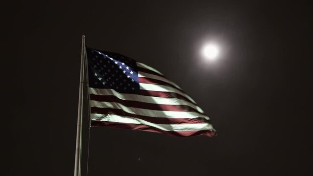 Lockdown Flag Of The United States Waving Against Clear Sky With Bright Moon At Night - San Francisco, California