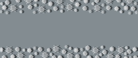 White snowflakes top and bottom on a gray background. New year and christmas concept.
