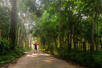 Fototapeta premium A man walking with arm open , enjoying the sunlight in the morning