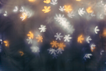 Christmas or New Year abstract magic lights background, snowflakes bokeh on dark as winter holiday...