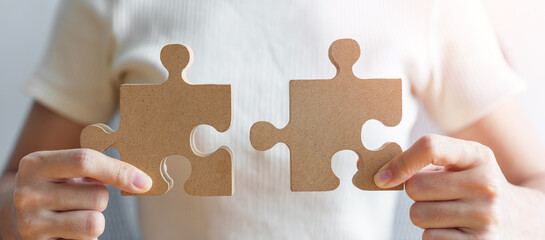 Hand connecting couple puzzle piece. Business Solving, mission, challenge, success, goals, target...