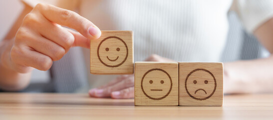 Hand choosing smile face from Emotion block.  customer review, good experience, positive feedback,...
