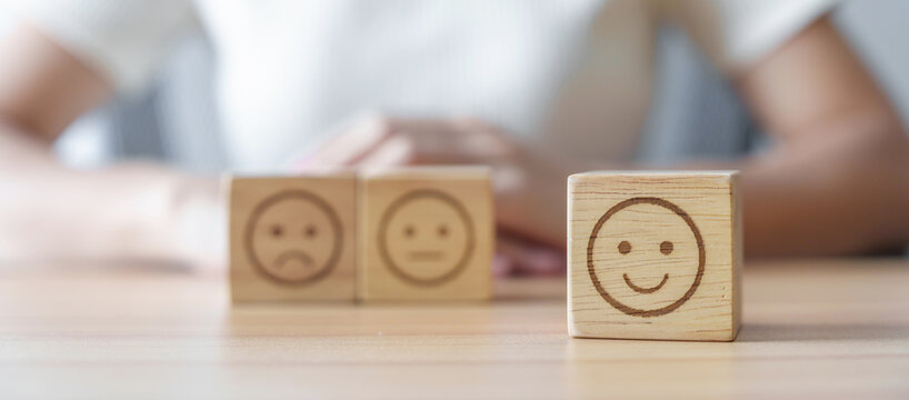 Happy smile face choosing from Emotion block for customer review, good experience, positive feedback, satisfaction, survey, evaluation, assessment, mood, world mental health day concept