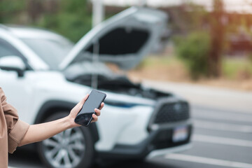 woman driver using mobile phone during problem car. Breakdown or broken car on road. Vehicle Insurance, maintenance and service concept