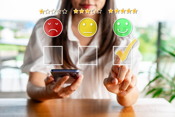Young woman traveler using smartphone to give a five-star satisfaction rating of the food and...
