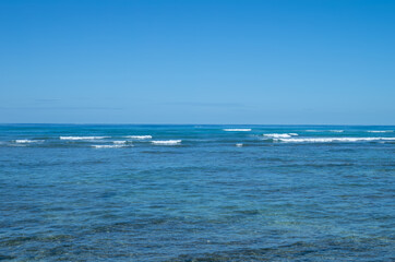 Fototapeta na wymiar Blue Ocean and Sky with a Horizon in the Background.
