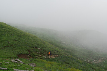 Trekking on mountain with green grass and cloudy in Manali, India