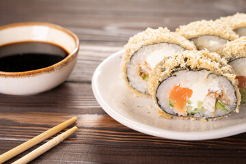 Hot fried sushi roll with salmon, avocado and cheese philadelphia. Sushi menu. Japanese food.