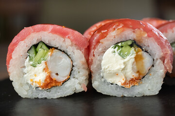 Sushi set, Japanese food, sushi roll with tuna and tiger shrimp on black stone background