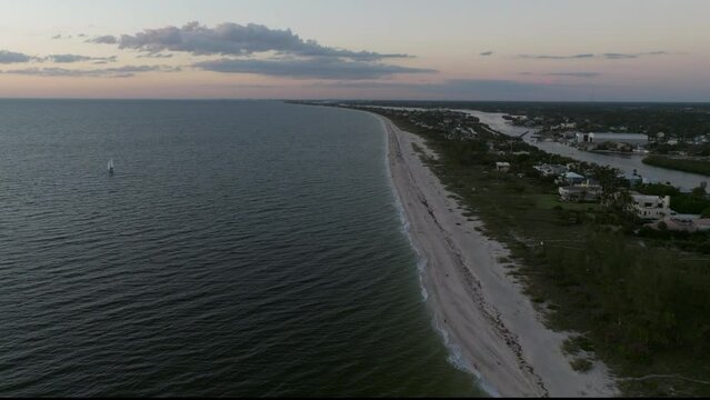 Flying north up Casey Key Beach at sunset